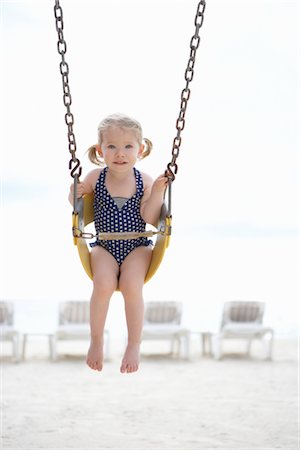 Girl Wearing Bathing Suit in Swing on Beach, Cancun, Mexico Stock Photo - Premium Royalty-Free, Code: 600-02686150
