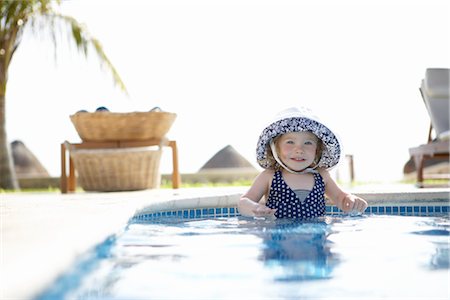 Girl Wearing Sunhat Standing in Swimming Pool, Cancun, Mexico Stock Photo - Premium Royalty-Free, Code: 600-02686152