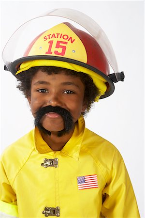 Boy Dressed as Firefighter Stock Photo - Premium Royalty-Free, Code: 600-02693685
