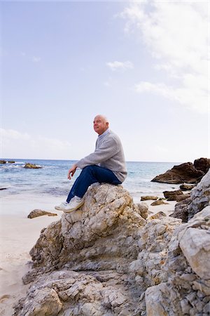 simsearch:700-01163568,k - Man Sitting on Rocks on the Beach Stock Photo - Premium Royalty-Free, Code: 600-02693904