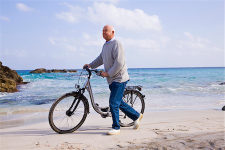 senior cycling not eye contact - Man With Bicycle on the Beach Stock Photo - Premium Royalty-Free, Code: 600-02693910