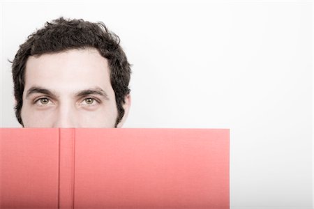 Portrait of Man Covering Face with Book Stock Photo - Premium Royalty-Free, Code: 600-02701081