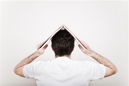 Back View of Man with Book on His Head Stock Photo - Premium Royalty-Free, Code: 600-02701082