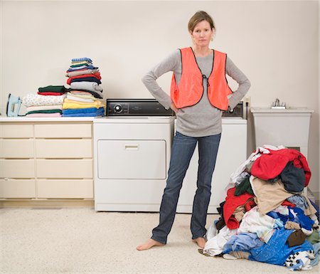 Woman Wearing Safety Vest Doing the Laundry Stock Photo - Premium Royalty-Free, Code: 600-02757060