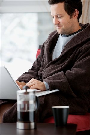 Man in Bathrobe Using Laptop Computer Stock Photo - Premium Royalty-Free, Code: 600-02757338