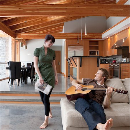 Couple at Home, Man Playing the Guitar Stock Photo - Premium Royalty-Free, Code: 600-02757349