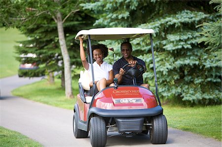 Couple Riding in Golf Cart Stock Photo - Premium Royalty-Free, Code: 600-02751463