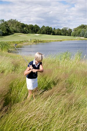 simsearch:640-06050635,k - Side View of Woman Golfing in Tall Grass Stock Photo - Premium Royalty-Free, Code: 600-02751528