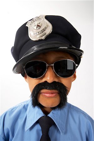 Boy Dressed as Police Officer Foto de stock - Sin royalties Premium, Código: 600-02786819