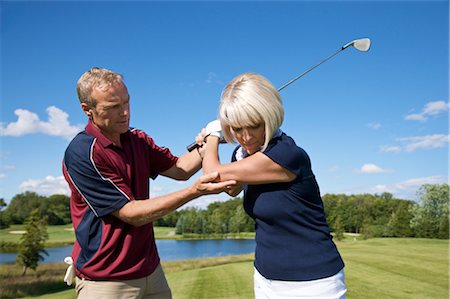 simsearch:640-06050635,k - Man Helping Woman With Her Golf Swing Stock Photo - Premium Royalty-Free, Code: 600-02833102