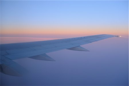 planes flying above the clouds - View of Aeroplane Wing at Sunrise Above Buenos Aires, Argentina Stock Photo - Premium Royalty-Free, Code: 600-02860277