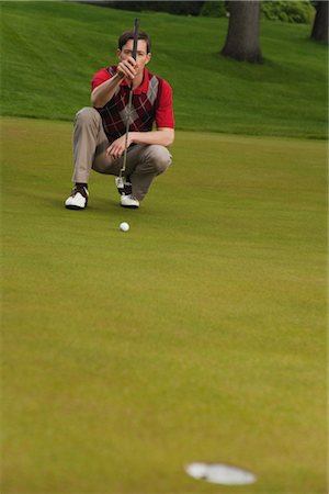 simsearch:6113-07159316,k - Man Assessing Golf Putt Stock Photo - Premium Royalty-Free, Code: 600-02883100