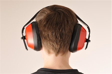 simsearch:600-03230190,k - Boy Wearing Antinoise Headphones Fotografie stock - Premium Royalty-Free, Codice: 600-02912555