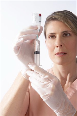 female nurse inject woman - Nurse Preparing a Needle Stock Photo - Premium Royalty-Free, Code: 600-02912805