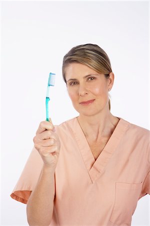 simsearch:600-03891313,k - Dental Assistant Holding Toothbrush Stock Photo - Premium Royalty-Free, Code: 600-02912846