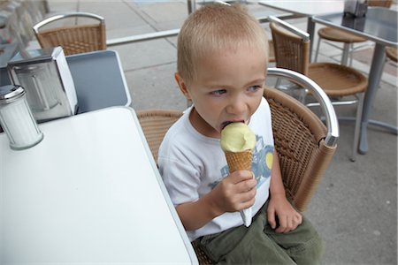 people seating at restaurant - Little Boy Eating Ice Cream on Restaurant Patio Stock Photo - Premium Royalty-Free, Code: 600-02922652