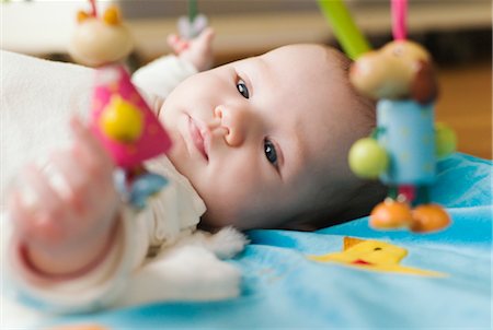 Baby Lying on Blanket with Toys Stock Photo - Premium Royalty-Free, Code: 600-03003859