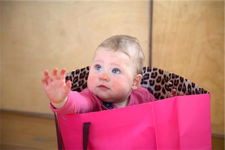 simsearch:600-02922776,k - Baby Girl Sitting in a Pink Shopping Bag Stock Photo - Premium Royalty-Free, Code: 600-03016956