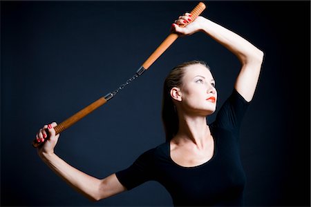 energetic fashion female - Woman Holding Nunchucks Stock Photo - Premium Royalty-Free, Code: 600-03075373