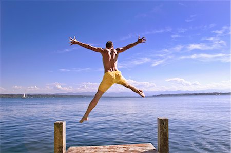 Man Jumping into Lake Stock Photo - Premium Royalty-Free, Code: 600-03152217