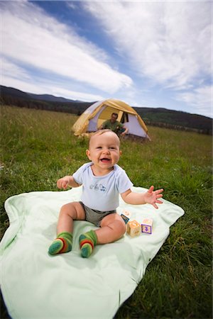 simsearch:600-01172751,k - Baby Sitting on a Blanket Outdoors, Father in a Tent in the Background, Steamboat Springs, Routt County, Colorado, USA Stock Photo - Premium Royalty-Free, Code: 600-03210482