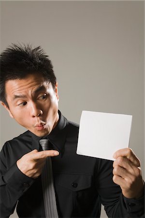 simsearch:600-03333357,k - Businessman Holding Blank Place Card Stock Photo - Premium Royalty-Free, Code: 600-03333256