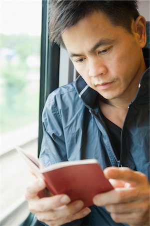 Man Reading Book on Train Stock Photo - Premium Royalty-Free, Code: 600-03333266