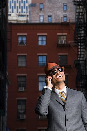 Businessman Laughing While on Mobile Phone Stock Photo - Premium Royalty-Free, Code: 600-03333274