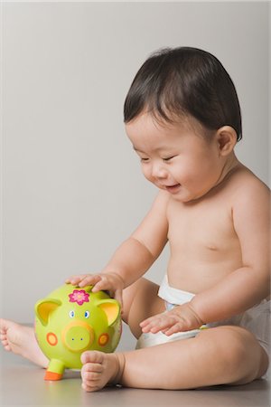 Little Boy with Piggy Bank Stock Photo - Premium Royalty-Free, Code: 600-03333344