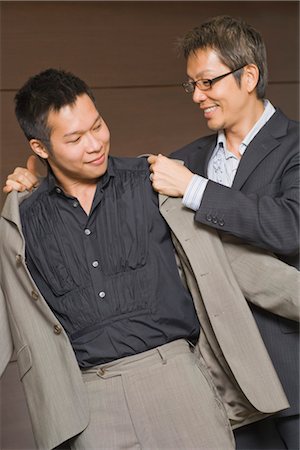 Man Helping His Partner With His Coat Stock Photo - Premium Royalty-Free, Code: 600-03333389