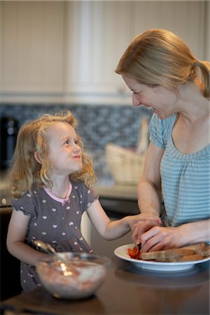 simsearch:600-03601499,k - Mother and Daughter Preparing Food in Kitchen Stock Photo - Premium Royalty-Free, Code: 600-03404172
