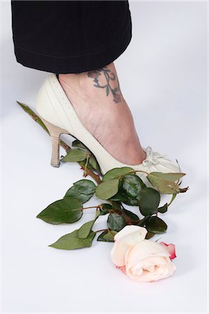 stamping (all meanings) - Woman With Tattoo Stepping on a Rose Stock Photo - Premium Royalty-Free, Code: 600-03404928