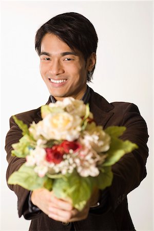 Man Holding Bouquet of Flowers Stock Photo - Premium Royalty-Free, Code: 600-03406488