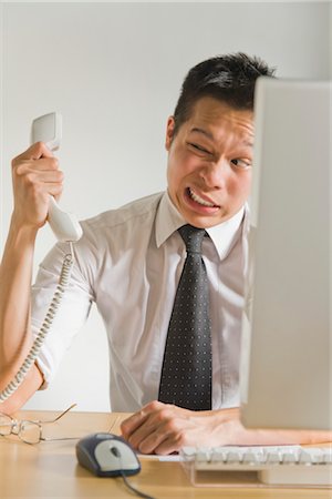 Businessman Being Yelled at Over Telephone Stock Photo - Premium Royalty-Free, Code: 600-03406483