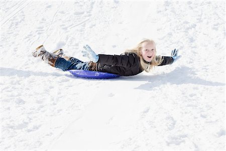 Girl Sledding in Winter Stock Photo - Premium Royalty-Free, Code: 600-03403767