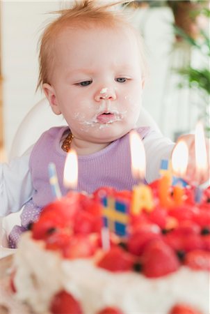 first birthday baby - Little Girl Looking at Cake Stock Photo - Premium Royalty-Free, Code: 600-03403923