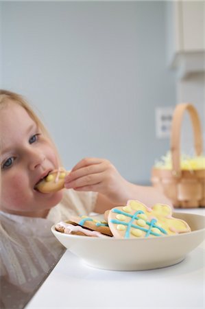 easter cookie - Little Girl Eating Easter Cookies Stock Photo - Premium Royalty-Free, Code: 600-03456687