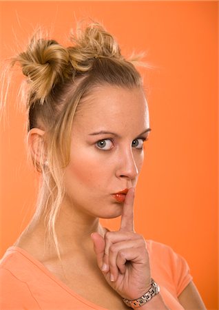 shhh - Woman with Finger to Lips Stock Photo - Premium Royalty-Free, Code: 600-03456818