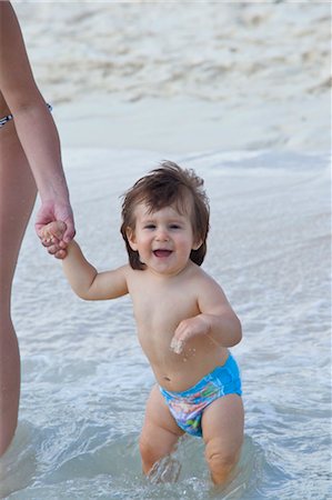 preschooler in diapers - Boy Holding Mother's Hand in Water at Beach, Mexico Stock Photo - Premium Royalty-Free, Code: 600-03456869