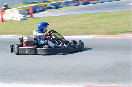 panning (camera technique) - Teenage Boy driving Go-Cart, Mexico Stock Photo - Premium Royalty-Free, Code: 600-03456893
