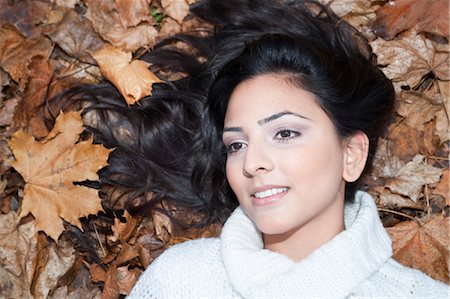 Woman Lying Down in Autumn Leaves Stock Photo - Premium Royalty-Free, Code: 600-03451499