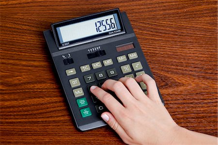 Woman Using Calculator Stock Photo - Premium Royalty-Free, Code: 600-03537953