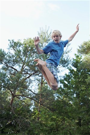 Boy Jumping Up in the Air Stock Photo - Premium Royalty-Free, Code: 600-03587327