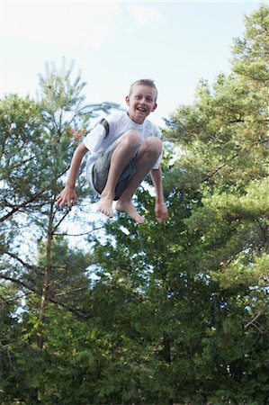 Boy Jumping Up in the Air Stock Photo - Premium Royalty-Free, Code: 600-03587328