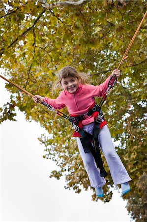 europe theme park - Girl in Jumping with Harness, Bordeaux, Gironde, Aquitaine, France Stock Photo - Premium Royalty-Free, Code: 600-03615790