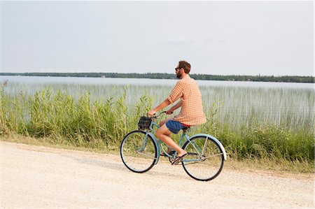 Man Riding Bike, Clearwater Lake Provincial Park, Manitoba, Canada Stock Photo - Premium Royalty-Free, Code: 600-03641266
