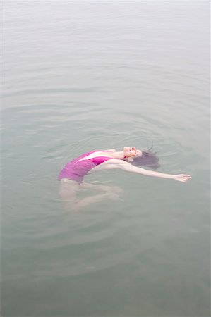 Woman Floating in Lake, Clearwater Lake Provincial Park, Manitoba, Canada Stock Photo - Premium Royalty-Free, Code: 600-03641268