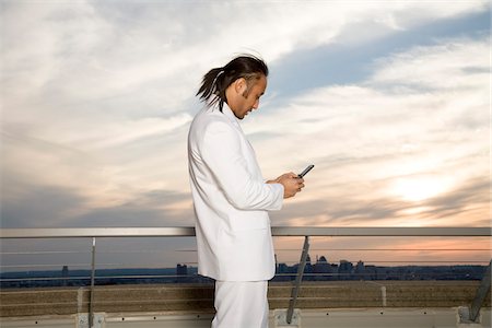 simsearch:700-06701841,k - Man Texting on Rooftop Stock Photo - Premium Royalty-Free, Code: 600-03692068
