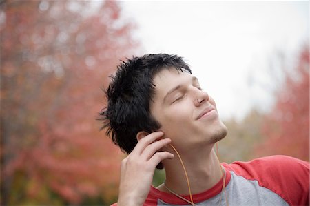 Young Man Listening to Music Stock Photo - Premium Royalty-Free, Code: 600-03692085