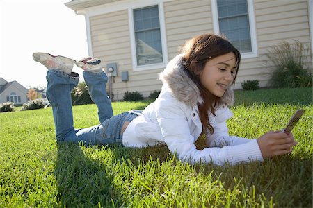 Girl Using Cellular Telephone Stock Photo - Premium Royalty-Free, Code: 600-03692082